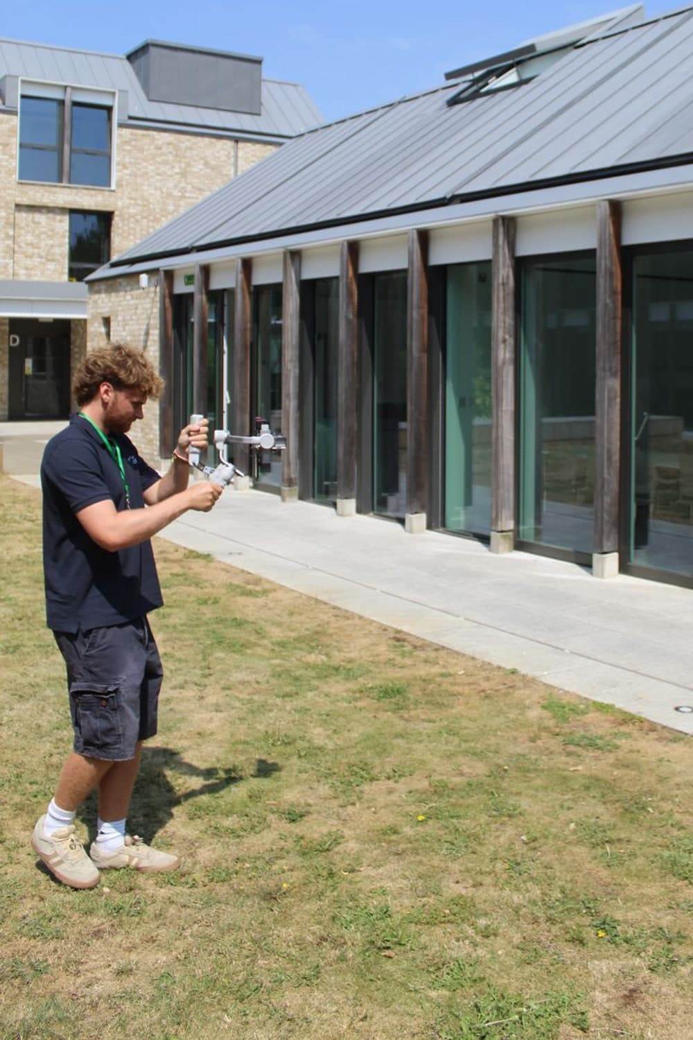 Filming exteriors with a stabilised camera outside a modern campus building